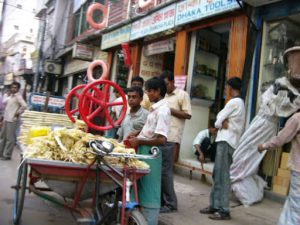 Dhaka - sugar cane grinder selling the sweet drink