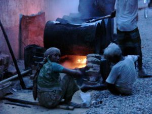 Dhaka - melting tar for road repairs.