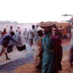 Dhaka - pouring hot tar on gravel (carried by women)