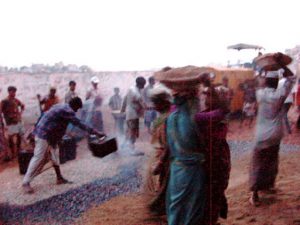 Dhaka - pouring hot tar on gravel (carried by women)