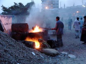 Dhaka - melting tar for road repairs