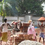Dhaka - grinding bricks for new construction.