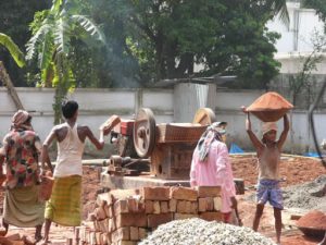 Dhaka - grinding bricks for new construction.