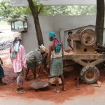 Dhaka - grinding and carrying bricks for new construction.