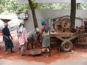 Dhaka - grinding and carrying bricks for new construction.
