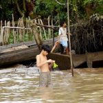 Repairing a fish net; children learn