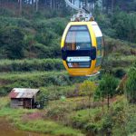 Modern cable car rides over ancient