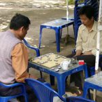 Waterfall park near Dalat - Men playing board game