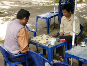 Waterfall park near Dalat - Men playing board game