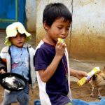 Rural farming village near Dalat - child eating candy