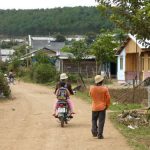 Rural farming village near Dalat - Guy on motorbike