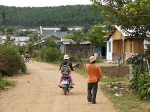 Rural farming village near Dalat - Guy on motorbike