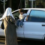 Amman - Woman with child in car window