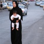 Amman - mother and child walking in the road