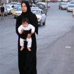 Amman - mother and child walking in the road