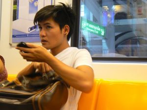 Thailand, Bangkok - on the SkyTrain virtually every young person