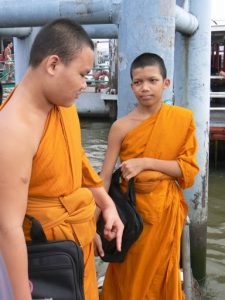 Thailand, Bangkok - young monks awaiting river ferry