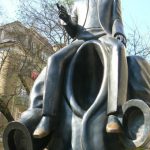 Statue and poster of Czech writer Franz Kafka.