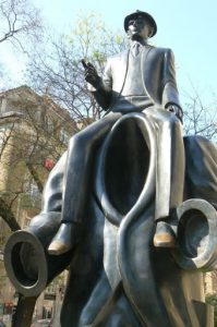 Statue and poster of Czech writer Franz Kafka.