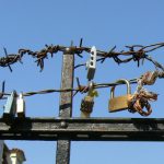 Locks attached to a barbed wire, symbolic of locking out