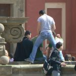 Playful tourists at a fountain behind St Vitus Cathedral.