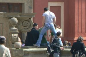 Playful tourists at a fountain behind St Vitus Cathedral.