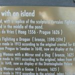 Plaque description of the statue of Hercules fighting a dragon.