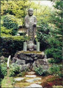 Kyoto: traditional Shinto statue figure holding the customary staff and