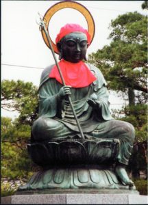 Buddha statue at the Zenko-ji Buddhist Temple holding symbolic objects.