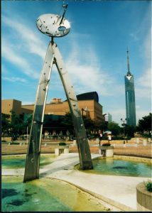 Sculpture near the library with Fukuoka Tower in the background.