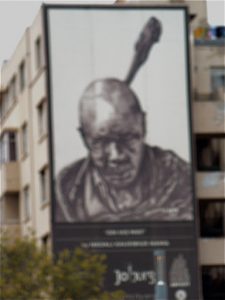 An unfortunately blurred billboard of a native rural dweller.