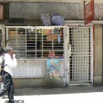 Local store downtown with protective cage on the front.