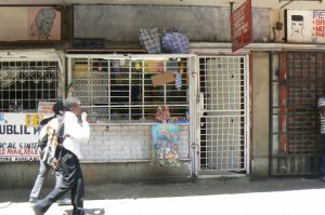 Local store downtown with protective cage on the front.