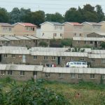 Middle class housing (background) and temporary housing for newly arrived