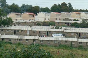 Middle class housing (background) and temporary housing for newly arrived