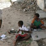 Kids playing along the street.