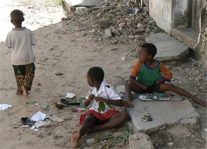 Kids playing along the street.