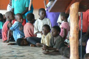 Children at church service: curious, wondering, amused.