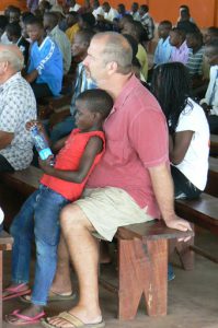 Staff member with a young boy; many children seek physical