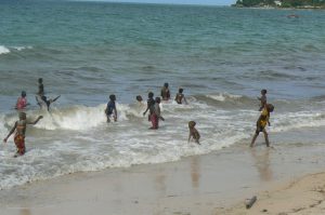 Local children enjoying the surf.