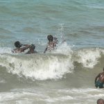 Local children enjoying the surf.