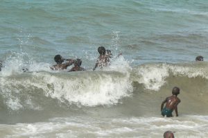 Local children enjoying the surf.