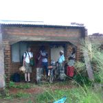 Waiting out a rain downpour halfway from Mandimba to Malawi.