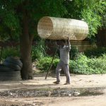 Basket weaver taking his wares to the Mangochi, market.