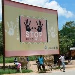 Roadside billboard advocating against child abuse.