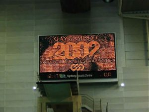 Scoreboard in the pool with Gay Games 2002 logo.