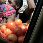 Food vendors surround a minibus at every stop.