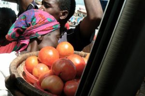 Food vendors surround a minibus at every stop.