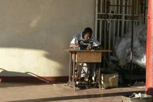 A tailor at this foot-powered sewing machine.