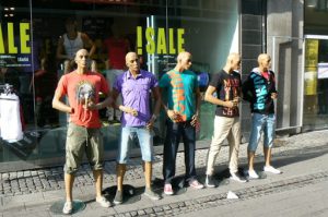 Mannequins dressed in rainbow colors along Stroget pedestrian street.